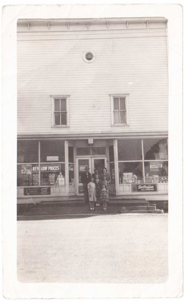 family in front of old general store